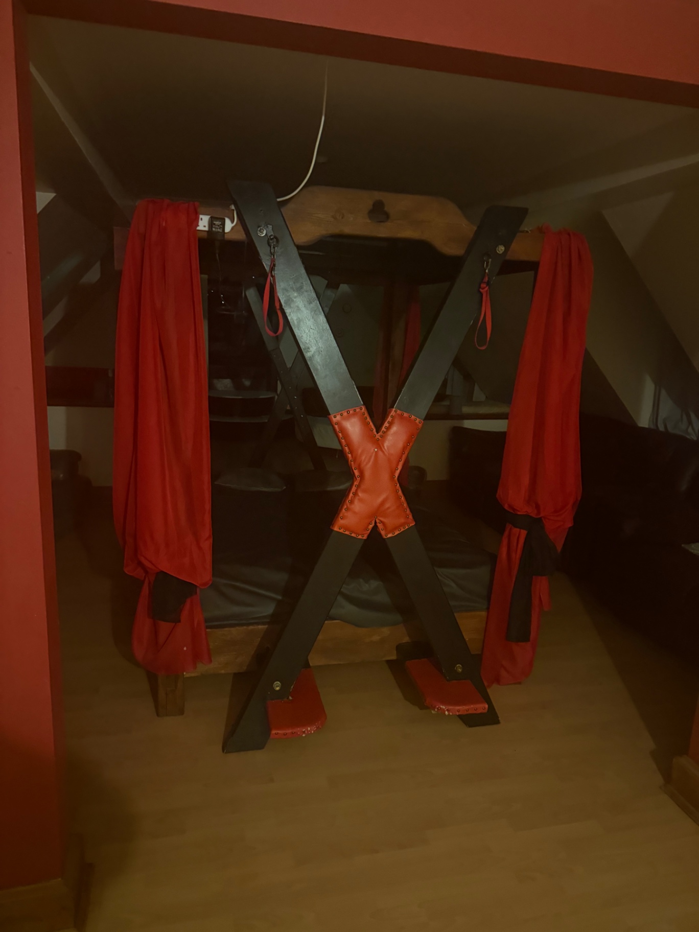St. Andrews cross framed by red curtains