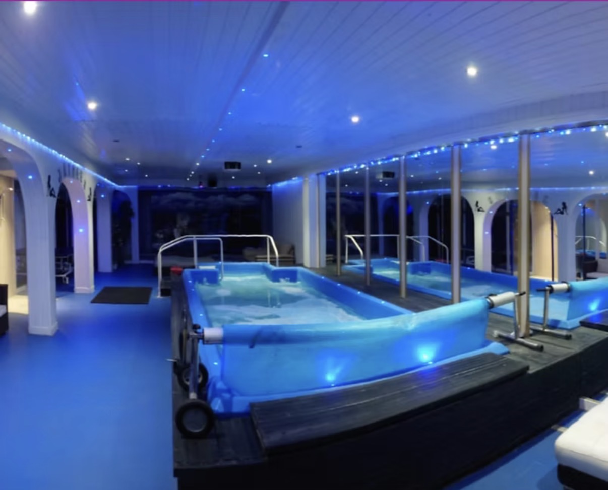 The 30-seater hot tub at Jaydees, softly lit in blue